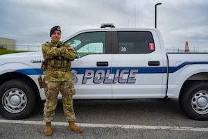 A1C Tinatin Sadzaglishvili poses for a photo next to a 105th Base Defense Group police truck.