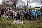 U.S. service members with Joint Task Force-Bravo, distribute food supplies in Amitty, Jamaica, Nov. 9, 2025. U.S. military forces are deployed to Jamaica at the direction of U.S. Southern Command to provide immediate, lifesaving assistance following Hurricane Melissa. (U.S. Marine Corps photo)