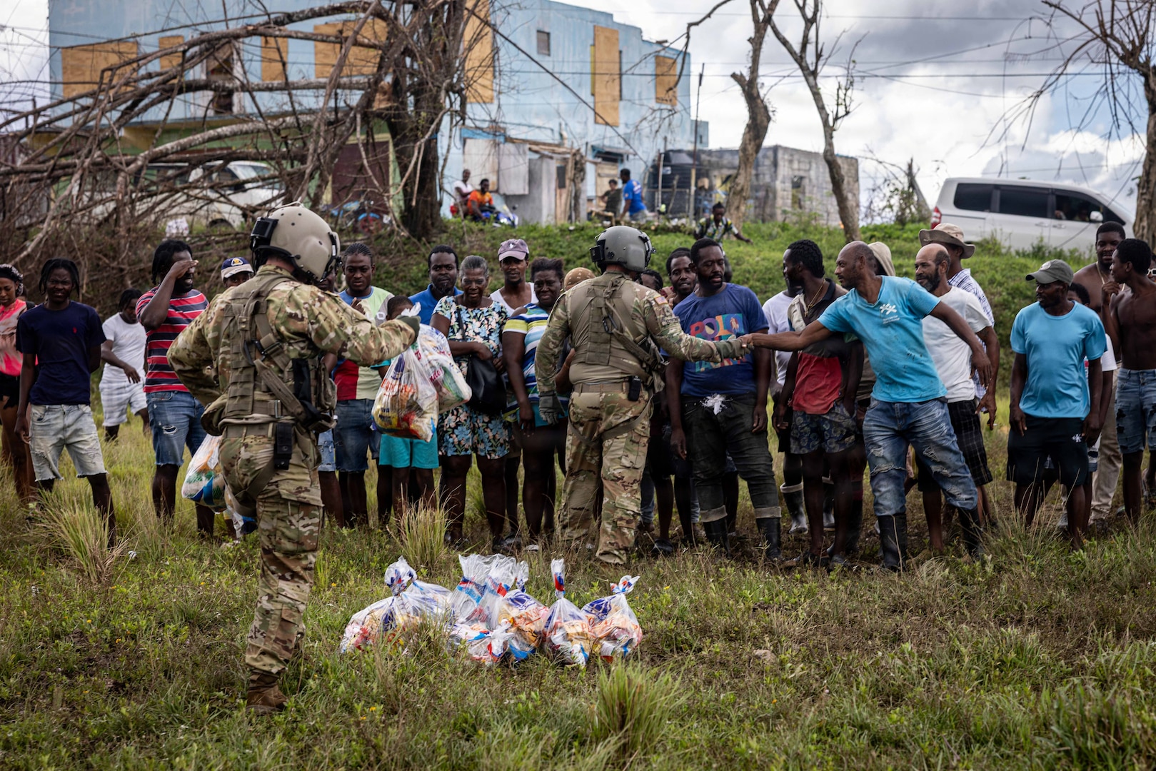 Military and civilian people greet each other