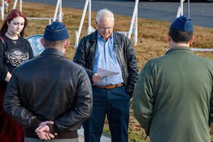 Retired U.S. Air Force Lt. Col. William “Mother” Forkner, Air Education and Training Command chief of combat air forces training branch, reads his speech on honoring Capt. Warren “Reefer” Sneed, former 14th Fighter Squadron assistant weapons officer, during a Veterans Day remembrance ceremony.