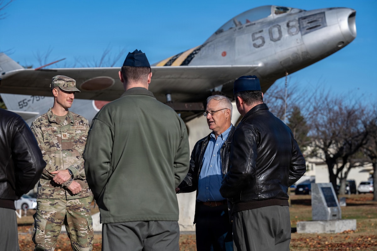 Retired U.S. Air Force Lt. Col. William “Mother” Forkner, center, Air Education and Training Command chief of combat air forces training branch, reads his speech on remembering Capt. Warren “Reefer” Sneed, once a 14th Fighter Squadron assistant weapons officer, during a Veterans Day remembrance ceremony.