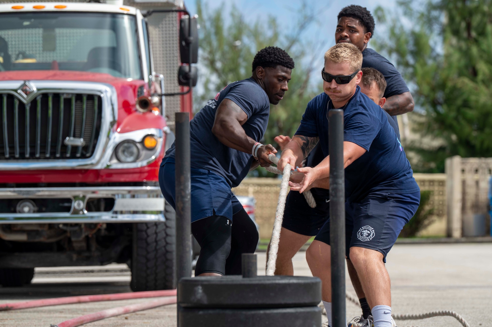 Members of the 36th Civil Engineer Squadron Fire Department pull a weighted sled during 2025 Fire Prevention Week muster at Andersen Air Force Base, Guam, Oct. 9, 2025.