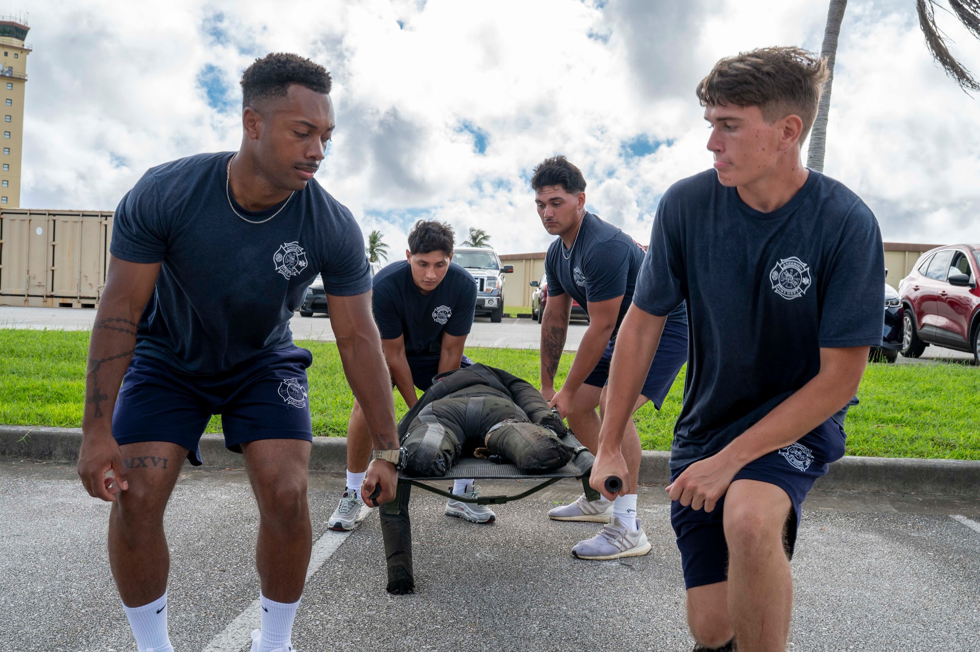 Members of the 36th Civil Engineer Squadron Fire Department demonstrate the stretcher carry during the 2025 Fire Prevention Week muster at Andersen Air Force Base, Guam, Oct. 9, 2025.