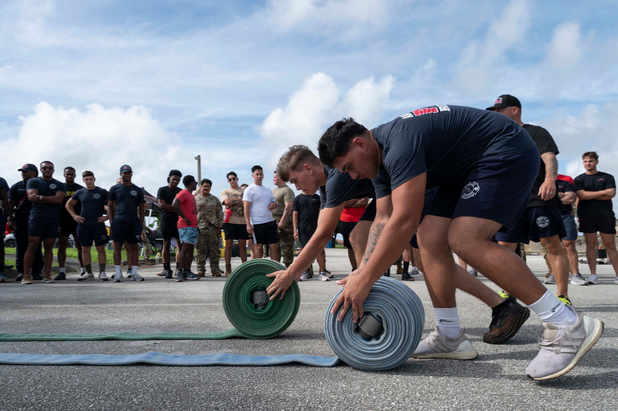 Crowds watch as members of the 36th Civil Engineer Squadron Fire Department demonstrate how to complete obstacles during the 2025 Fire Prevention Week muster at Andersen Air Force Base, Guam, Oct. 9, 2025.