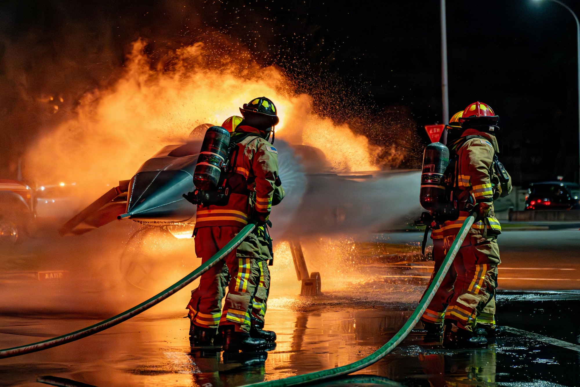 U.S. Air Force Airmen assigned to the 35th Civil Engineer Squadron spray a simulated burning aircraft during Fire Prevention Week 2025.
