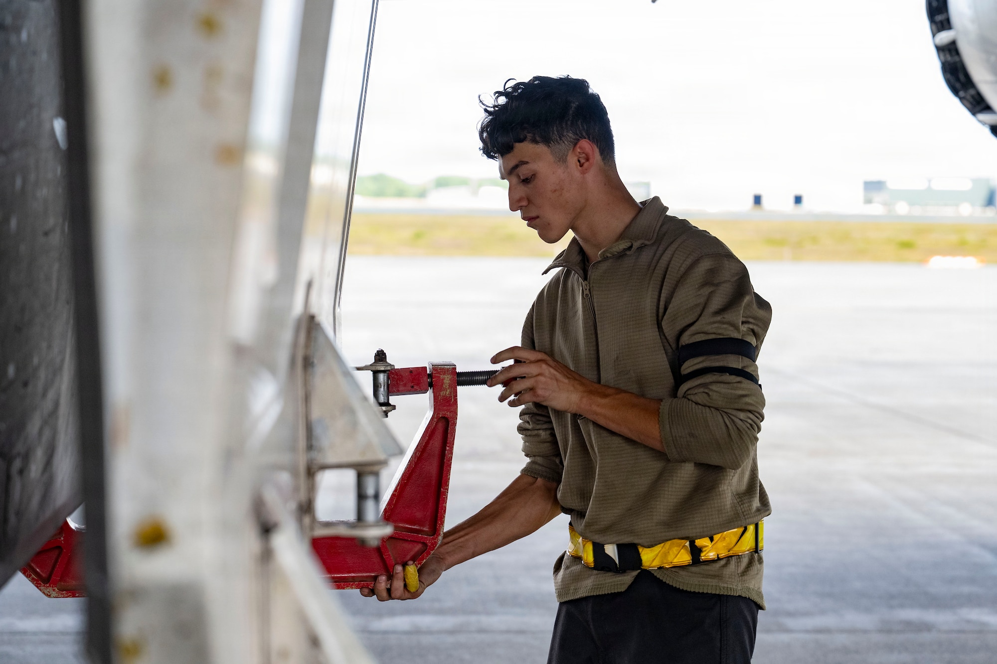 A maintainer works outside on a plane