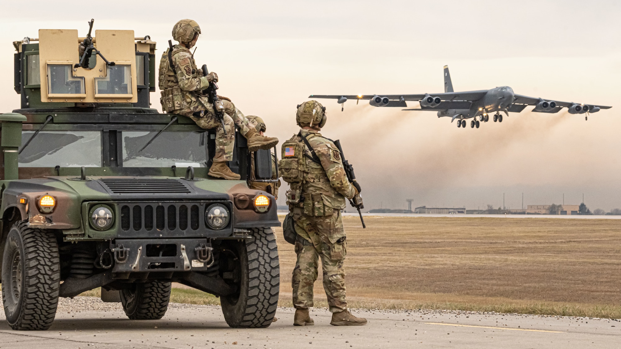 Airmen assigned to the 5th Security Forces Squadron, Minot Air Force Base, North Dakota, watch a B-52H Stratofortress take off as part of Exercise Global Thunder 26 at Minot AFB, North Dakota, Oct. 26, 2025. Global Thunder is an annual command and control exercise designed to train U.S. Strategic Command Forces and assess joint operational readiness.