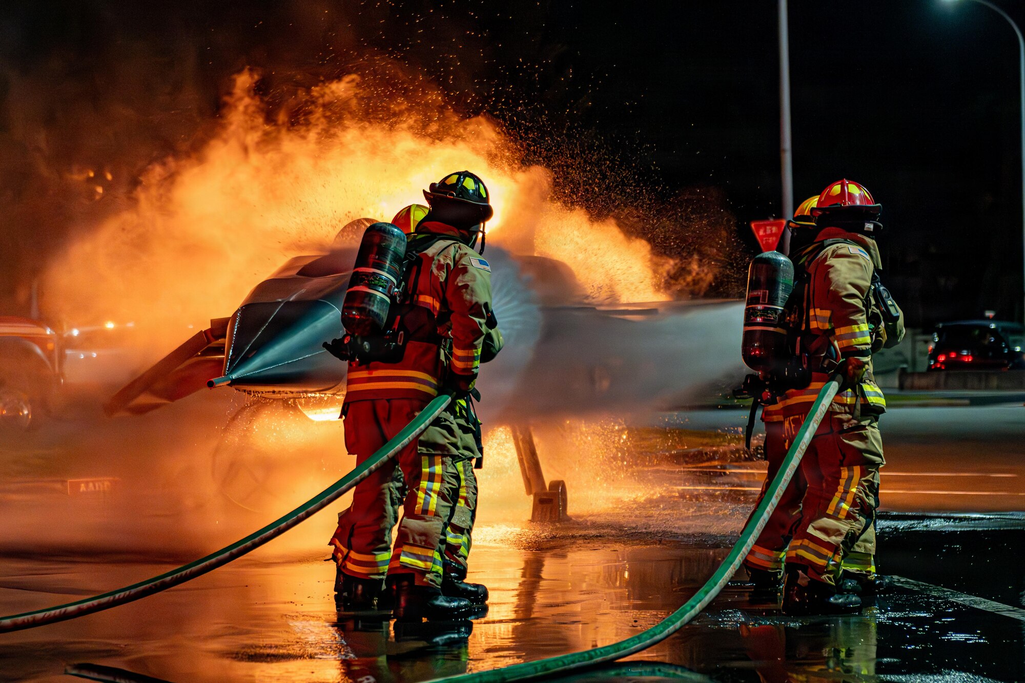 U.S. Air Force Airmen assigned to the 35th Civil Engineer Squadron spray a simulated burning aircraft during Fire Prevention Week 2025.