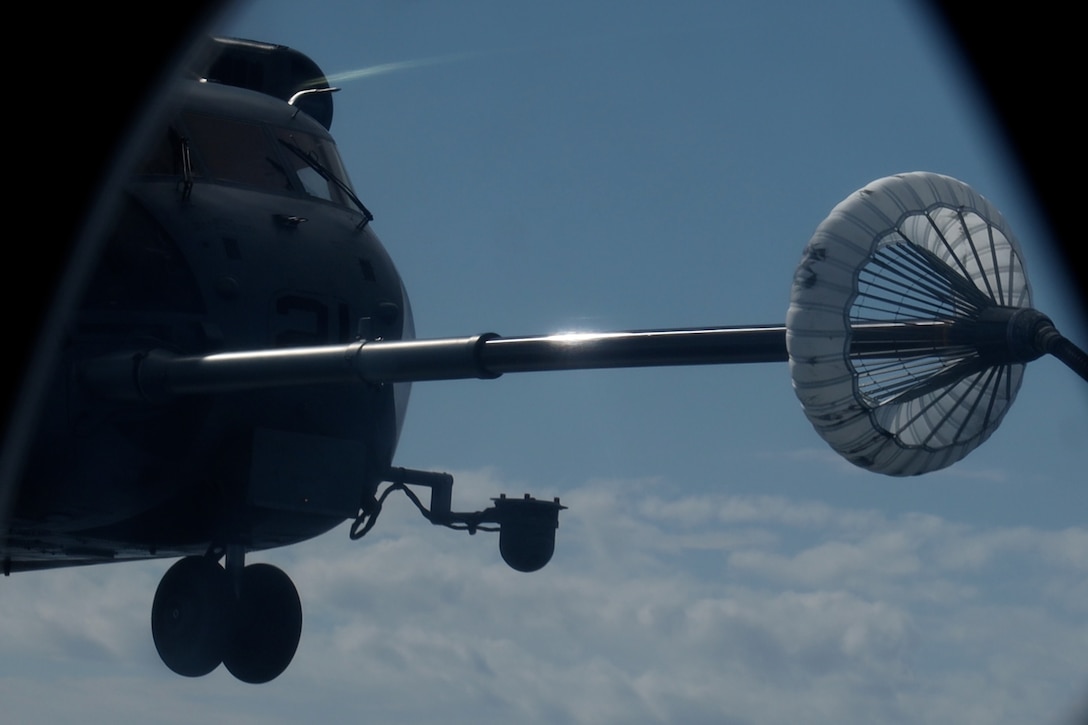 A U.S. Marine Corps CH-53E Super Stallion assigned to Marine Medium Tiltrotor Squadron (VMM) 265 (Rein), 31st Marine Expeditionary Unit, conducts mid-air refueling during flight operations in the Philippine Sea, Sep. 26, 2025. The Marines conducted flight operations demonstrating multi-domain transport capabilities to support combined-joint all domain operations. The 31st MEU, the Marine Corps’ only continuously forward deployed MEU, provides a flexible and lethal force, ready to perform a wide range of military operations as the premiere crisis response force in the Indo-Pacific region. (U.S. Marine Corps photo by Lance Cpl. Gerardo Mendez)