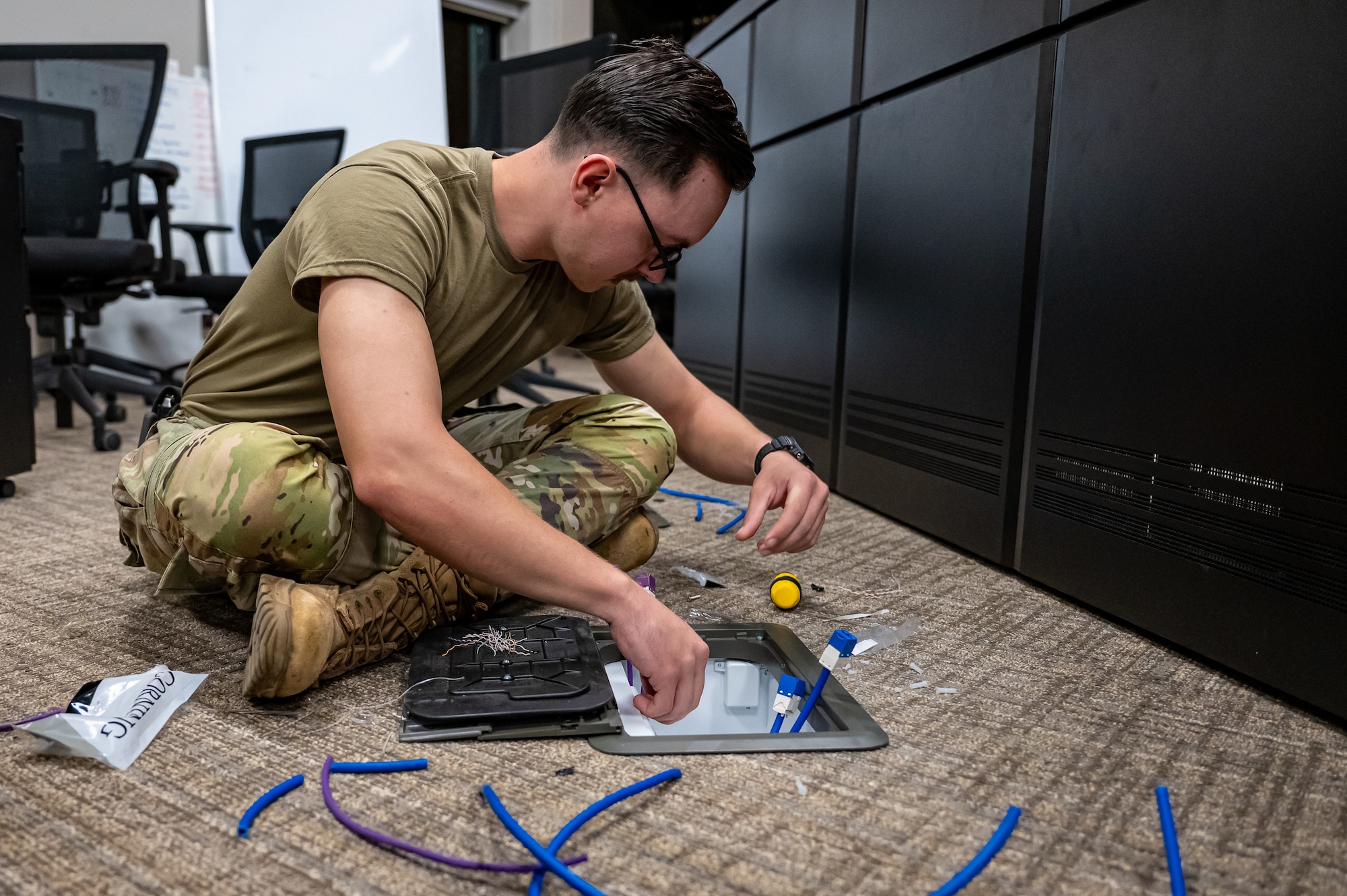 U.S. Air Force Airman 1st Class William Bentley, 85th Engineering Installation Squadron cyber transport engineer, installs fiber-optic cable in the 36th Wing Installation Control Center at Andersen Air Force Base, Guam, Sept. 17, 2025.