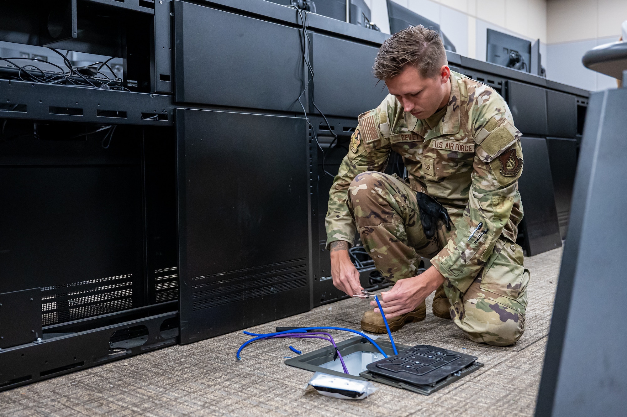 U.S. Air Force Staff Sgt. Taylor Devett, 85th Engineering Installation Squadron cable antenna technician, installs fiber-optic cable in the 36th Wing Installation Control Center at Andersen Air Force Base, Guam, Sept. 17, 2025.