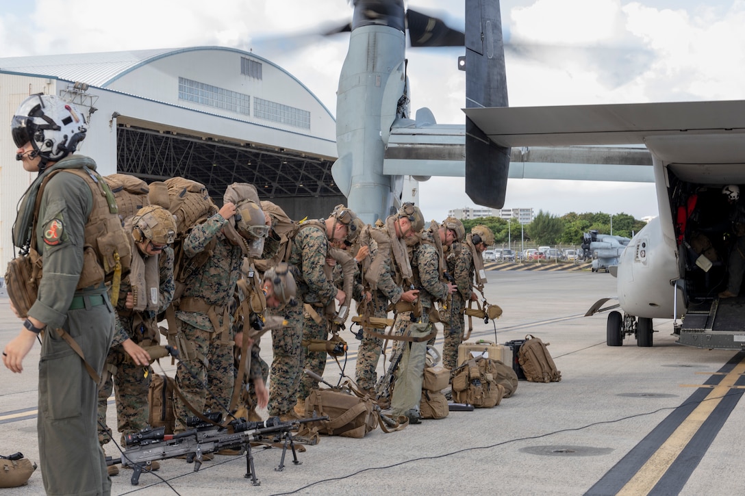 U.S. Marines with Battalion Landing Team 1st Battalion, 7th Marine Regiment, 31st Marine Expeditionary Unit, conduct a personal protective equipment inspection before loading onto a U.S. Marine Corps MV-22B Osprey assigned to Marine Medium Tiltrotor Squadron (VMM) 265 (Rein.), 31st MEU, during flight operations at Marine Corps Air Station Futenma, Okinawa, Japan, Sept. 26, 2025. The Marines conducted flight operations demonstrating multi-domain transport capabilities of the 31st MEU. The 31st MEU, the Marine Corps’ only continuously forward-deployed MEU, provides a flexible and lethal force, ready to perform a wide range of military operations as the premiere crisis response force in the Indo-Pacific region. (U.S. Marine Corps photo by Lance Cpl. Skilah Sanchez)