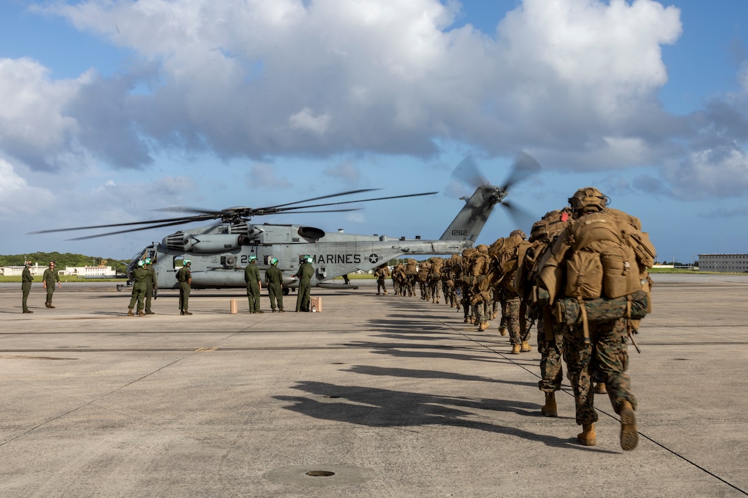 U.S. Marines with Battalion Landing Team 1st Battalion, 7th Marine Regiment, 31st Marine Expeditionary Unit, load onto a U.S. Marine Corps CH-53E Super Stallion assigned to Marine Medium Tiltrotor Squadron (VMM) 265 (Rein.), 31st MEU, during flight operations at Marine Corps Air Station Futenma, Okinawa, Japan, Sept. 26, 2025. The Marines conducted flight operations demonstrating multi-domain transport capabilities of the 31st MEU. The 31st MEU, the Marine Corps’ only continuously forward-deployed MEU, provides a flexible and lethal force, ready to perform a wide range of military operations as the premiere crisis response force in the Indo-Pacific region. (U.S. Marine Corps photo by Lance Cpl. Skilah Sanchez)