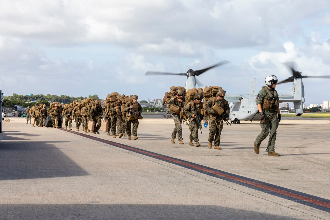 U.S. Marines with Battalion Landing Team 1st Battalion, 7th Marine Regiment, 31st Marine Expeditionary Unit, prepare to load onto a U.S. Marine Corps MV-22B Osprey assigned to Marine Medium Tiltrotor Squadron (VMM) 265 (Rein.), 31st MEU, during flight operations at Marine Corps Air Station Futenma, Okinawa, Japan, Sept. 26, 2025. The Marines conducted flight operations demonstrating multi-domain transport capabilities of the 31st MEU. The 31st MEU, the Marine Corps’ only continuously forward-deployed MEU, provides a flexible and lethal force, ready to perform a wide range of military operations as the premiere crisis response force in the Indo-Pacific region. (U.S. Marine Corps photo by Lance Cpl. Skilah Sanchez)