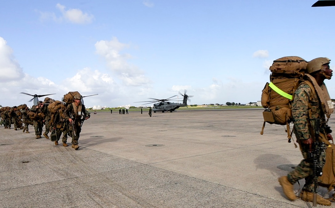 U.S. Marines with Battalion Landing Team 1st Battalion, 7th Marine Regiment, 31st Marine Expeditionary Unit, prepare to load onto a U.S. Marine Corps MV-22B Osprey assigned to Marine Medium Tiltrotor Squadron (VMM) 265 (Rein.), 31st MEU, during flight operations at Marine Corps Air Station Futenma, Okinawa, Japan, Sept. 26, 2025. The Marines conducted flight operations demonstrating multi-domain transport capabilities of the 31st MEU. The 31st MEU, the Marine Corps’ only continuously forward-deployed MEU, provides a flexible and lethal force, ready to perform a wide range of military operations as the premiere crisis response force in the Indo-Pacific region. (U.S. Marine Corps photo by Lance Cpl. Skilah Sanchez)