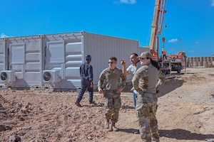 U.S. Air Force Airmen assigned to the 475th Expeditionary Air Base Squadron Civil Engineer and Contracting Flights observe progress on an ongoing construction site at Camp Simba.