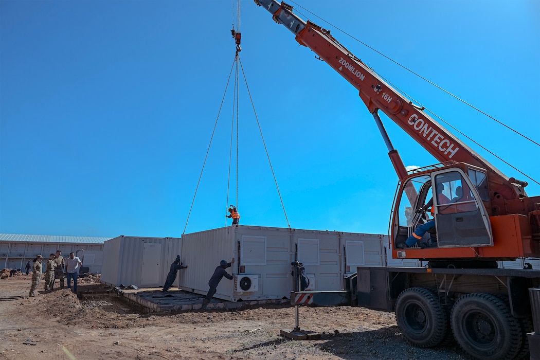 U.S. Air Force Airmen assigned to the 475th Expeditionary Air Base Squadron Civil Engineer and Contracting Flights observe progress on an ongoing construction site at Camp Simba.