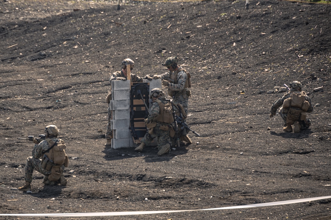 U.S. Marines with Battalion Landing Team 1st Battalion, 7th Marine Regiment, 31st Marine Expeditionary Unit, apply a C4 and detonating cord charge onto a simulated cinderblock wall during live-fire training at Combined Arms Training Center, Camp Fuji, Japan, Sept. 29, 2025. Marines conducted combined arms live-fire training to maintain operational readiness, tactical proficiency, and enhance lethality while operating within the first island chain. The 31st MEU, the Marine Corps’ only continuously forward-deployed MEU, provides a flexible and lethal force ready to perform a wide range of military operations as the premiere crisis response force in the Indo-Pacific region. (U.S. Marine Corps photo by Lance Cpl. Victor Gurrola)
