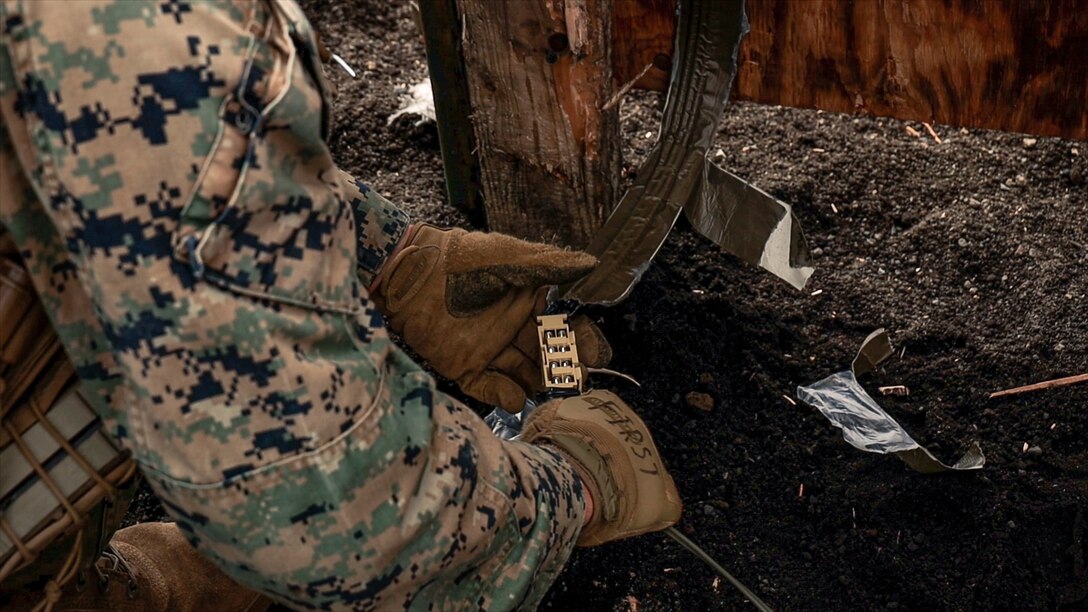 A U.S. Marine with Battalion Landing Team 1st Battalion, 7th Marine Regiment, 31st Marine Expeditionary Unit, crimps a detonating cord charge to the fuse during live-fire training at Combined Arms Training Center, Camp Fuji, Japan, Sept. 29, 2025. Marines conducted combined arms live-fire training to maintain operational readiness, tactical proficiency, and enhance lethality while operating within the first island chain. The 31st MEU, the Marine Corps’ only continuously forward-deployed MEU, provides a flexible and lethal force ready to perform a wide range of military operations as the premiere crisis response force in the Indo-Pacific region. (U.S. Marine Corps photo by Lance Cpl. Victor Gurrola)