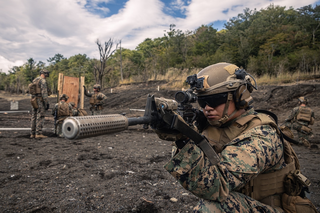 U.S. Marine Corps Cpl. Amareni Sanchez, a combat engineer with Animal Company, Battalion Landing Team 1st Battalion, 7th Marine Regiment, 31st Marine Expeditionary Unit, sets security with an M4 carbine while her fireteam applies a detonating cord charge onto a simulated door during live-fire training at Combined Arms Training Center, Camp Fuji, Japan, Sept. 29, 2025. Marines conducted combined arms live-fire training to maintain operational readiness, tactical proficiency, and enhance lethality while operating within the first island chain. The 31st MEU, the Marine Corps’ only continuously forward-deployed MEU, provides a flexible and lethal force ready to perform a wide range of military operations as the premiere crisis response force in the Indo-Pacific region. Sanchez is a native of Oregon. (U.S. Marine Corps photo by Lance Cpl. Victor Gurrola)