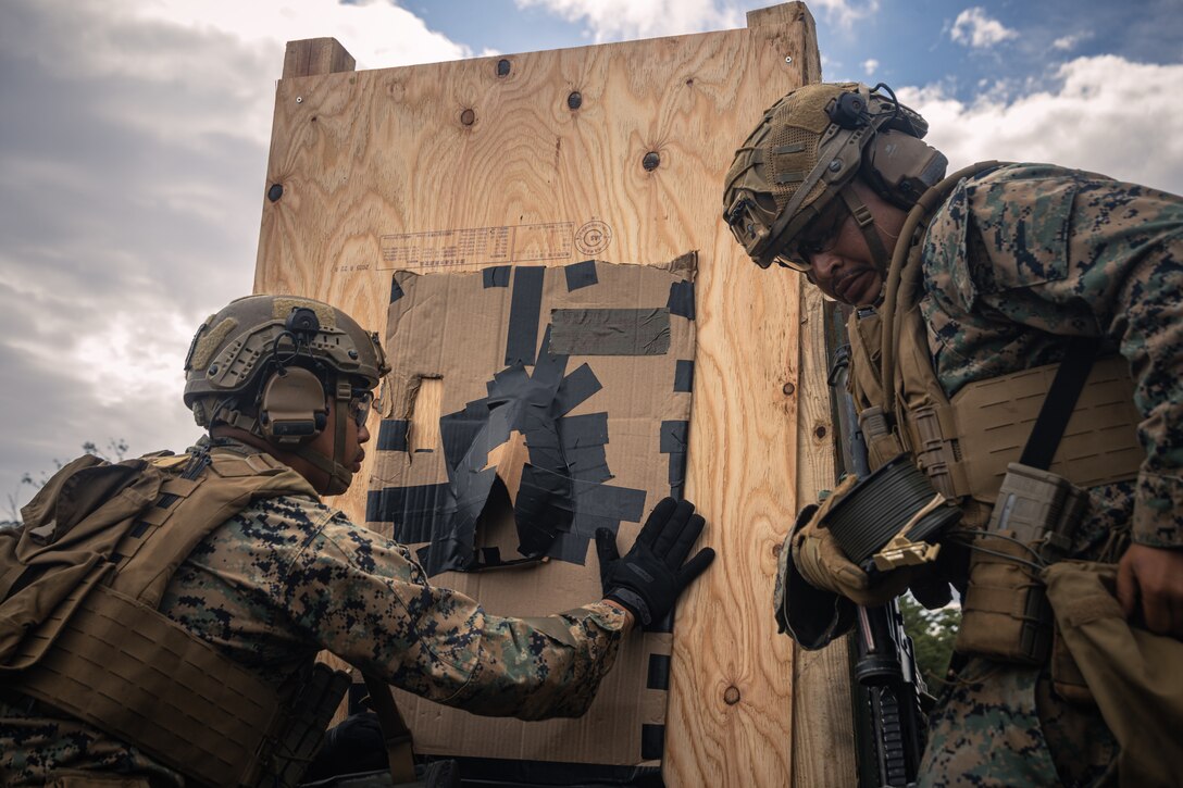 U.S. Marines with Battalion Landing Team 1st Battalion, 7th Marine Regiment, 31st Marine Expeditionary Unit, apply a detonating cord charge onto a simulated door during live-fire training at Combined Arms Training Center, Camp Fuji, Japan, Sept. 29, 2025. Marines conducted combined arms live-fire training to maintain operational readiness, tactical proficiency, and enhance lethality while operating within the first island chain. The 31st MEU, the Marine Corps’ only continuously forward-deployed MEU, provides a flexible and lethal force ready to perform a wide range of military operations as the premiere crisis response force in the Indo-Pacific region. (U.S. Marine Corps photo by Lance Cpl. Victor Gurrola)