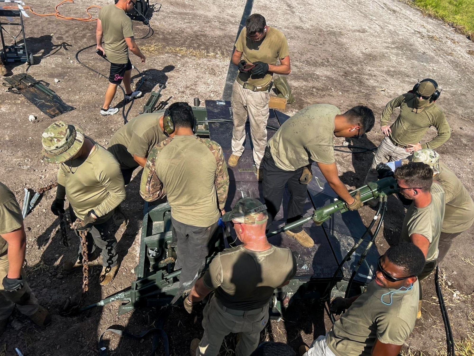 U.S. Air Force RED HORSE Airmen assigned to Det 336 install a Mobile Aircraft Arresting System amid intense environmental conditions during a deployment to U.S. Navy Support Facility Diego Garcia, British Indian Ocean Territory.