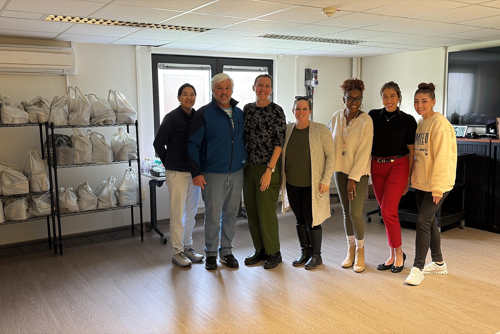 The Ramstein Military and Family Readiness Center staff pose for a group photo in the limited Emergency Family Assistance Center at Ramstein Air Base, Germany, Nov. 13, 2025.