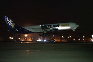 Patriot Express takes off on a runway during the night.
