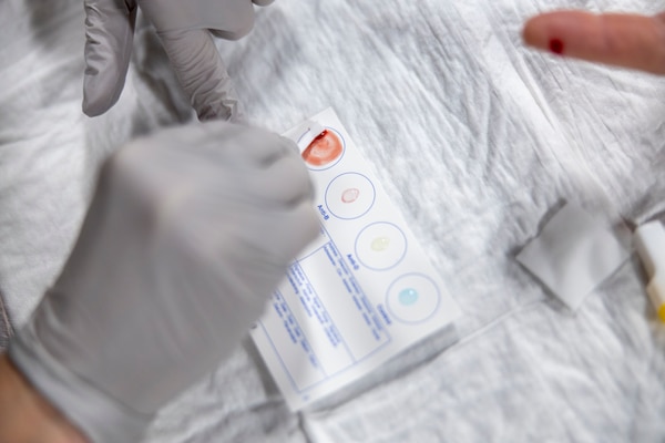 U.S. Navy LT. Cmdr. Alexandria Johnston, a medical officer assigned to the Harpers Ferry-Class Dock Landing Ship USS Carter Hall (LSD 50), takes a blood sample from a fellow classmate during a Tier IV Tactical Casualty Combat Care course hosted by 2nd Marine Logistics Group at Marine Corps Base Camp Lejeune, North Carolina, Sept. 29, 2025. 2nd MLG became the first-ever Marine Corps command to host a Tier IV TCCC course and is now hosting its second iteration. The course trains select military service members to become proficient combat paramedics capable of providing advanced casualty care at the point of injury on the battlefield and in austere environments. (U.S. Marine Corps photo by Lance Cpl. Isabella Ramos)