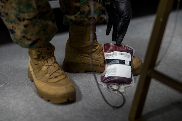 U.S. Navy LT. Soterios Stroud, an emergency medicine specialist with 2nd Medical Battalion, 2nd Marine Logistics Group, practices drawing blood during a tier IV Tactical Casualty Combat Care course at Marine Corps Base Camp Lejeune, North Carolina, Sept. 29, 2025. 2nd MLG became the first-ever Marine Corps command to host a Tier IV TCCC course and is now hosting its second iteration. The course trains select military service members to become proficient combat paramedics capable of providing advanced casualty care at the point of injury on the battlefield and in austere environments. (U.S. Marine Corps photo by Lance Cpl. Isabella Ramos)
