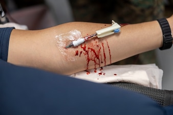 A U.S. Navy Sailor with 2nd Medical Battalion, 2nd Marine Logistics Group, practices drawing blood during a Tier IV Tactical Casualty Combat Care course at Marine Corps Base Camp Lejeune, North Carolina, Sept. 29, 2025. 2nd MLG became the first-ever Marine Corps command to host a Tier IV TCCC course and is now hosting its second iteration. The course trains select military service members to become proficient combat paramedics capable of providing advanced casualty care at the point of injury on the battlefield and in austere environments. (U.S. Marine Corps photo by Lance Cpl. Isabella Ramos)