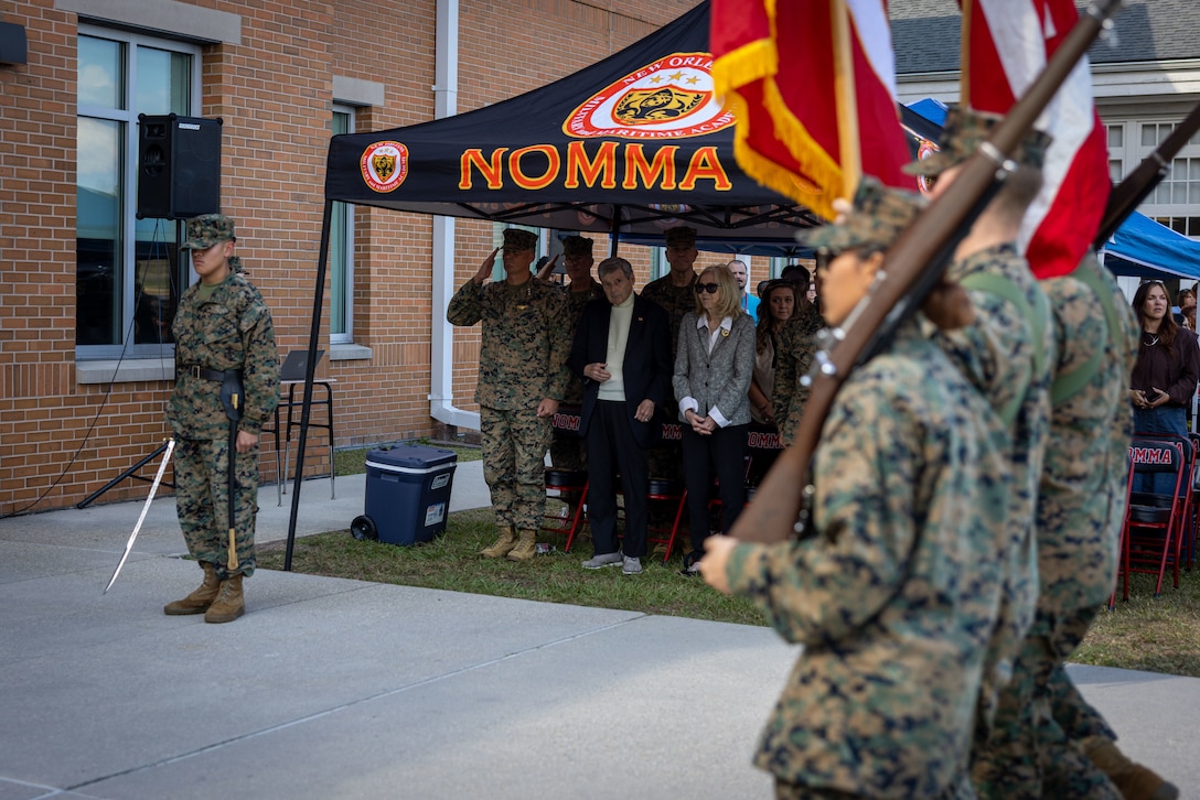 Students with New Orleans Military and Maritime Academy march colors past U.S. Marine Corps Lt. Gen. Leonard F. Anderson IV, commander, Marine Forces Reserve and Marine Forces South, during a ceremony celebrating the 250th Marine Corps birthday, in New Orleans, Nov. 14, 2025. The ceremony consisted of speeches by guest speakers U.S. Marine Corps Lt. Gen. Leonard F. Anderson IV, commander, Marine Forces Reserve and Marine Forces South, and Sgt. Maj. Edwin A. Mota, command senior enlisted leader, the marching of colors, cake-cutting and the reading of the birthday message. (U.S. Marine Corps photo by Lance Cpl. Juan Diaz)