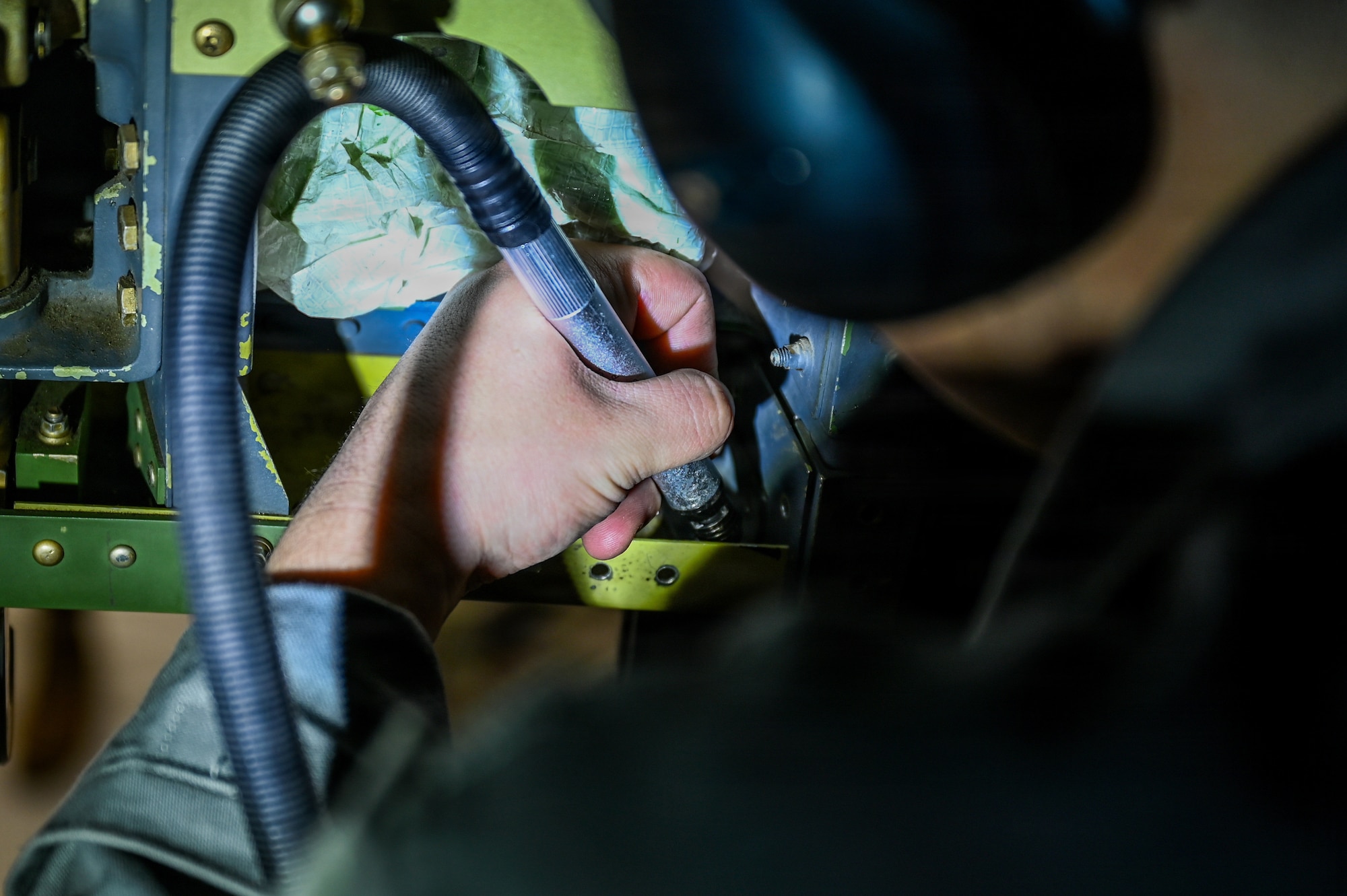 U.S. Air Force Senior Airman Kadin Trahan, 86th Maintenance Squadron aircraft structural maintenance journeyman, removes excess metal from a jettison bracket for a C-130J Super Hercules at Ramstein Air Base, Germany, Nov. 13, 2025.