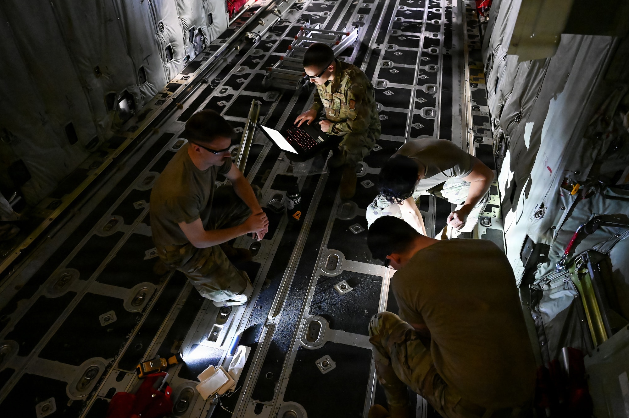 U.S. Air Force Airmen assigned to the 86th Maintenance Squadron and the 86th Aircraft Maintenance Squadron repair floor panels inside a C-130J Super Hercules at Ramstein Air Base, Germany, Nov.13, 2025.