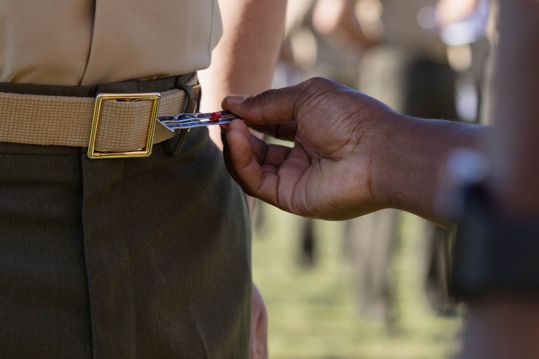 U.S. Marine Corps Sgt. Maj. Kabiru M. Labaran, sergeant major of Headquarters Battalion, Marine Forces Reserve and Marine Forces South, inspects the length of a belt during an inspection of U.S. Marines with Marine Forces South, Marine Corps Support Facility New Orleans, Oct. 24, 2025. The inspection was conducted to evaluate the Marines’ appearance and adherence to standards while promoting discipline and attention to detail. (U.S. Marine Corps photo by Lance Cpl. Van Hoang)