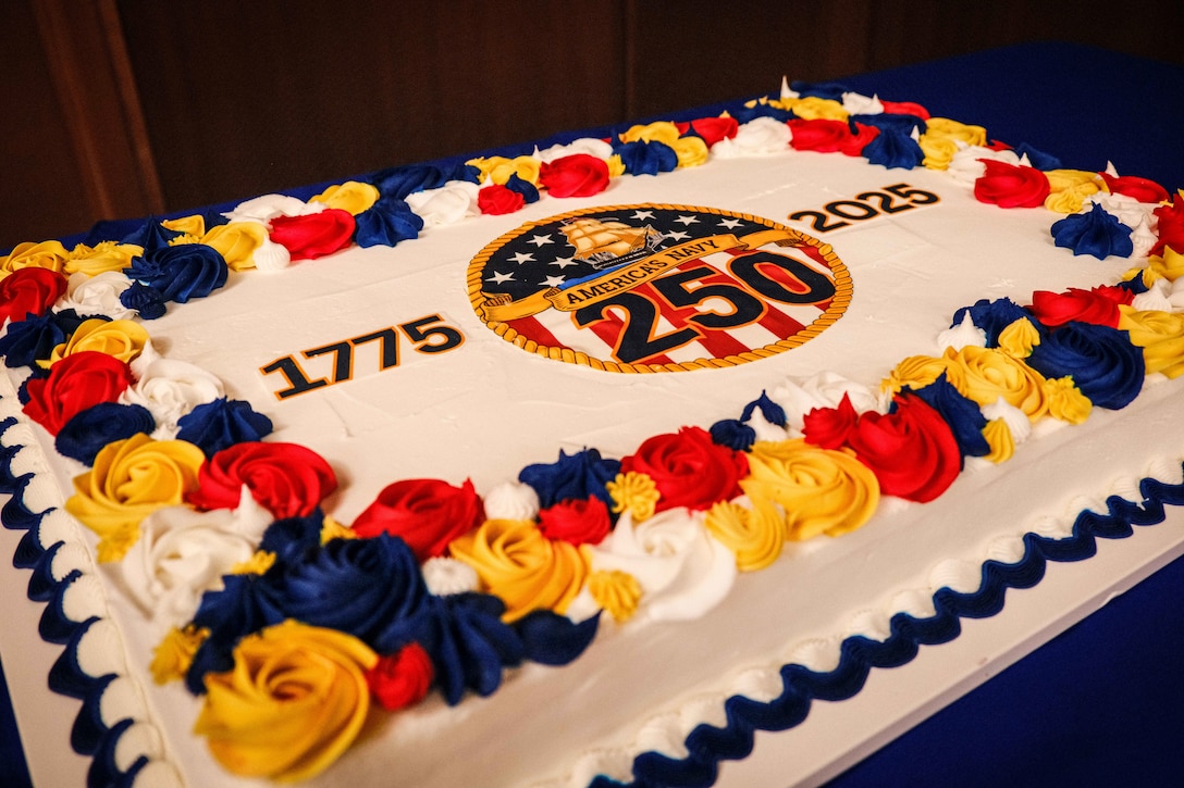 A cake is displayed before the Navy's 250th birthday ceremony at Marine Corps Support Facility New Orleans, Oct. 15, 2025. The Navy's birthday cake cutting ceremony between the oldest and youngest Sailors symbolizes the passing of knowledge and tradition from one generation to the next. (U.S. Marine Corps photo by Lance Cpl. Priscilla Flores)