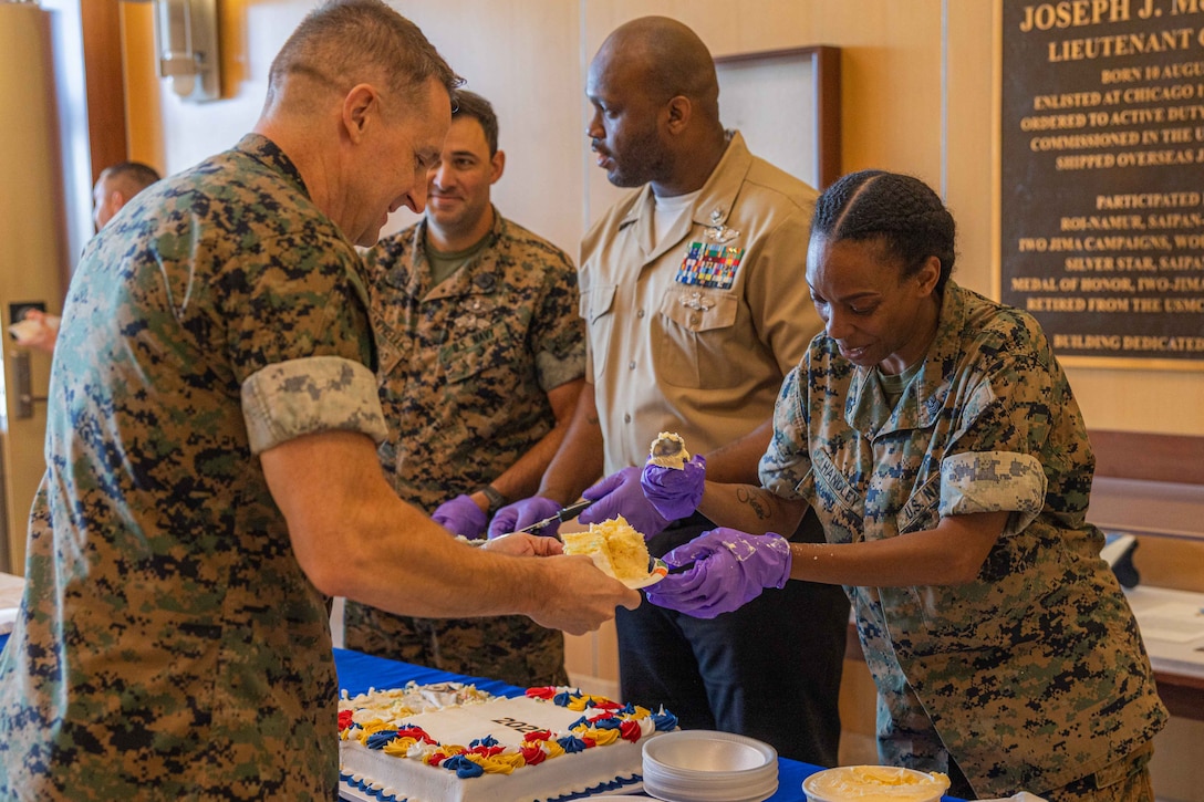 U.S. Navy Petty Officer 1st Class Natashia Handley, personnel supervisor, Marine Forces Reserve, serves cake and ice cream to a guest at the Navy's 250th birthday ceremony at Marine Corps Support Facility New Orleans, Oct. 15, 2025. MARFORRES has more than 1,000 Sailors serving at more than 150 Marine Corps Reserve training centers across the nation supporting the Total Force to be ready to fight and win our nation's battles. (U.S. Marine Corps photo by Lance Cpl. Edward Spears)
