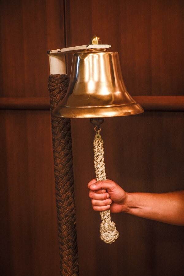 U.S. Navy Hospital Corpsman 1st Class Drake O’Conor De Los Rios, Marine Forces Reserve, rings a bell during the Navy's 250th birthday ceremony at Marine Corps Support Facility New Orleans, Oct. 15, 2025. To ring the bell symbolizes the presence of the people of the past, as well as signifying the future of the Navy. MARFORRES has more than 1,000 Sailors serving at more than 150 Marine Corps Reserve training centers across the nation supporting the Total Force to be ready to fight and win our nation's battles. (U.S. Marine Corps photo by Lance Cpl. Priscilla Flores)