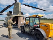 Will Wilson, with the North Carolina Urban Search and Rescue Task Force 11, uses a forklift to load pallets of water onto a CH-47F Chinook helicopter piloted by Soldiers with B Company, 2nd Battalion, 104th Aviation Regiment, Connecticut Army National Guard during Hurricane Helene response efforts in Salisbury, North Carolina, Sept 27, 2024.
