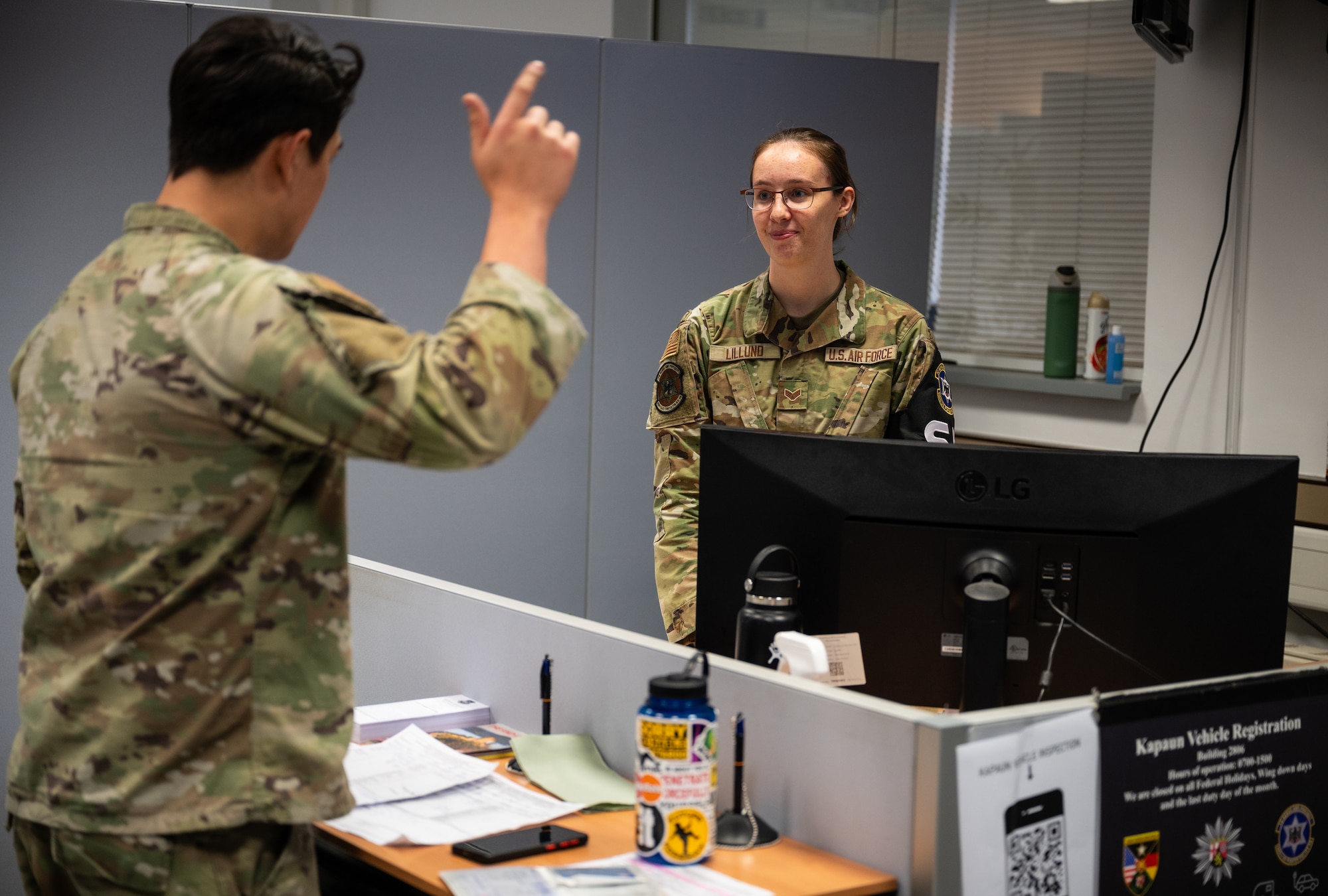 U.S. Air Force Senior Airman Hannah Lillund, 569th United States Forces Police Squadron vehicle registration clerk, helps Airman 1st Class Jacob Stuart, 86th Logistics Readiness Squadron material management journeyman, register his vehicle at Kapaun Air Station, Germany, Nov. 3, 2025. Lillund was off duty when she heard neighbors calling for help and provided aid that saved the life of a nine-month-old girl on Oct. 12. (U.S. Air Force photo by Senior Airman Jared Lovett)