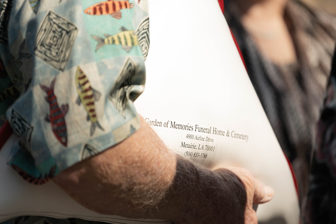 Wayne Bodker holds a U.S. flag that was draped over the casket of U.S. Marine Corps Sgt. Frank Schmaltz at the Garden of Memories Funeral Home and Cemetery, Metairie, Louisiana, Oct. 13, 2025. The flag is a tribute of lasting importance to our service members, veterans and their families. (U.S. Marine Corps photo by Lance Cpl. Van Hoang)