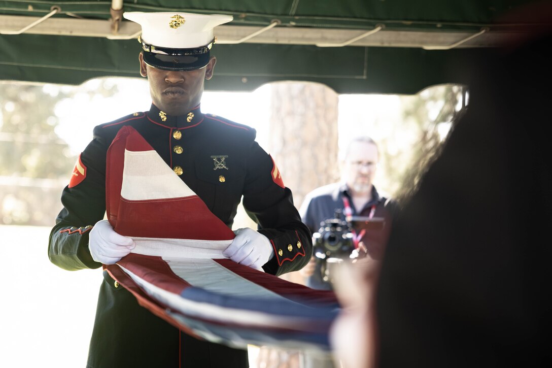 U.S. Marine Corps Lance Cpl. Moses James, systems engineer, Headquarters Battalion, Marine Forces Reserve, folds a U.S. flag for the family of Sgt. Frank Schmaltz at the Garden of Memories Funeral Home and Cemetery, Metairie, Louisiana, Oct. 13, 2025. Marine Corps Funeral Honors stands committed to ensuring that every Marine who has served receives the proper respects, serving as a final tribute to their life and a lasting demonstration of the nation's appreciation for their unwavering defense of our country, whether in times of conflict or peace. (U.S. Marine Corps photo by Lance Cpl. Van Hoang)