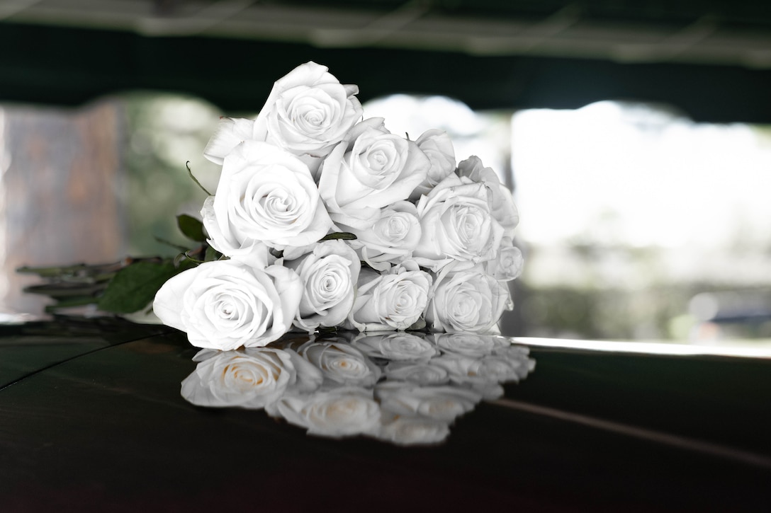 Flowers lay on the casket of U.S. Marine Corps Sgt. Frank Schmaltz at the Garden of Memories Funeral Home and Cemetery, Metairie, Louisiana, Oct. 13, 2025. Marine Corps Funeral Honors stands committed to ensuring that every Marine who has served receives the proper respects, serving as a final tribute to their life and a lasting demonstration of the nation's appreciation for their unwavering defense of our country, whether in times of conflict or peace. (U.S. Marine Corps photo by Lance Cpl. Van Hoang)