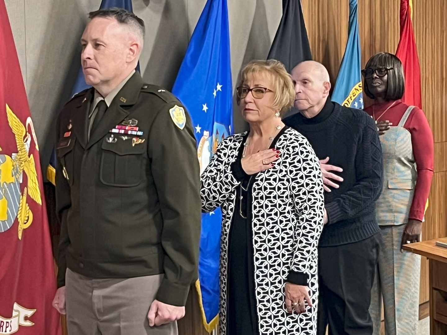 DLA Troop Support Commander Army Brig. Gen. Sean P. Kelly. Stands at attention during the playing of the National Anthem before a retirement ceremony in Philadelphia on Nov 17. In order behind Kelly stand; Lynne DeSanto, David Friedman, and Renee Fitchett.