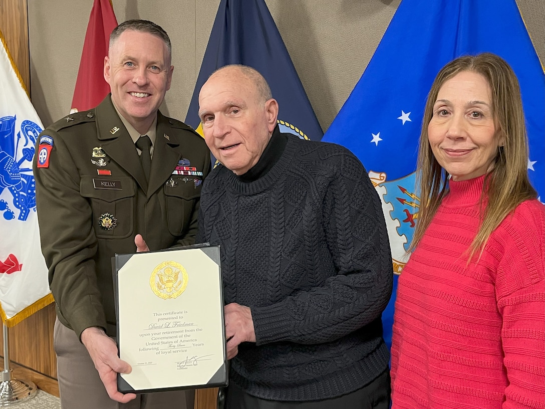 David Friedman stands with his spouse Mindy, and DLA Troop Support Commander Army Brig. Gen. Sean P. Kelly during Friedman’s retirement ceremony from Troop Support in Philadelphia on Nov 17