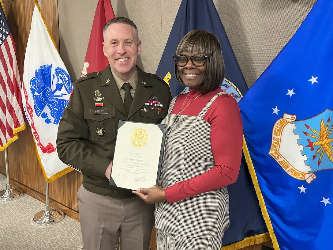 Renee Fitchett stands with DLA Troop Support Commander Army Brig. Gen. Sean P. Kelly during Fitchett’s retirement ceremony from Troop Support in Philadelphia on Nov 17.