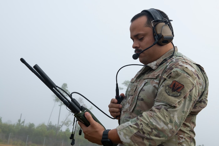 Airman using a hand held radio