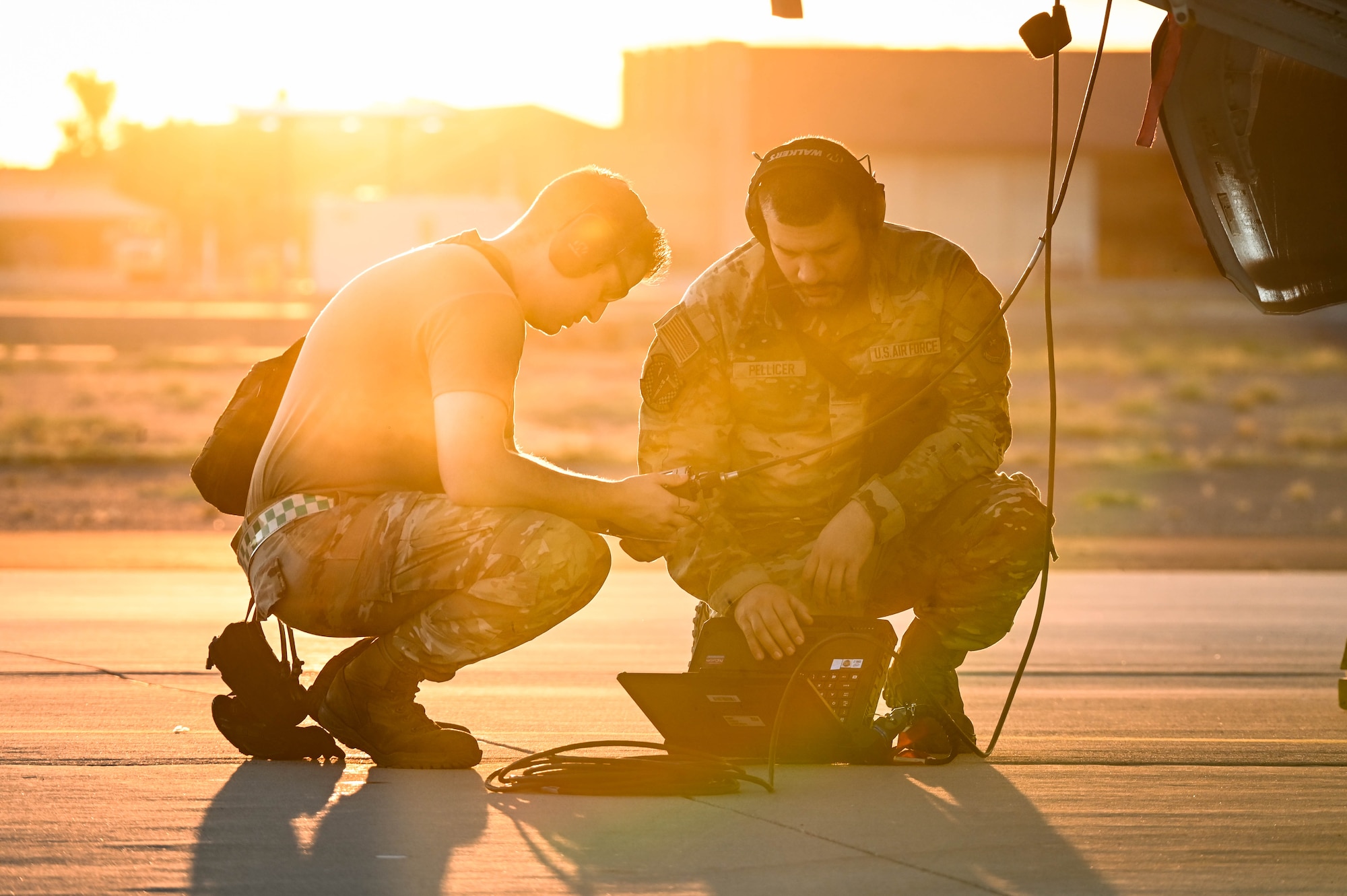 U.S. Air Force Staff Sgt. Ryan Fields (left) and Senior Airman Raphael Pellicer (right), 308th Aircraft Maintenance Unit F-35A Lightning II integrated avionics specialists, ready a jet for flight during a Phase 2 Aircraft Generation exercise