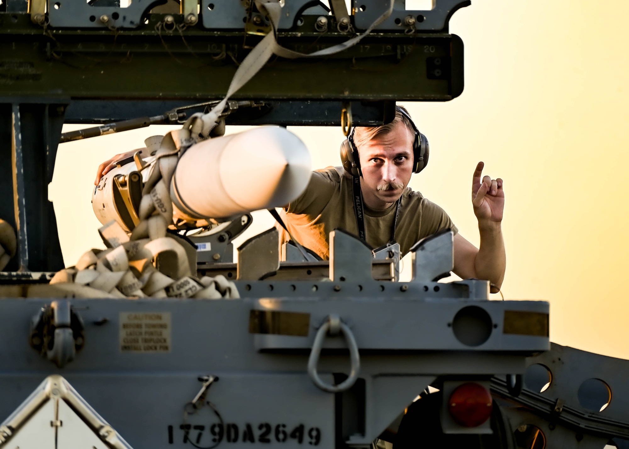 U.S. Air Force Staff Sgt. Derek Rushing, 62nd Aircraft Maintenance Unit aircraft armament systems specialist, loads a weapon onto a jammer during a Phase 2 Aircraft Generation exercise