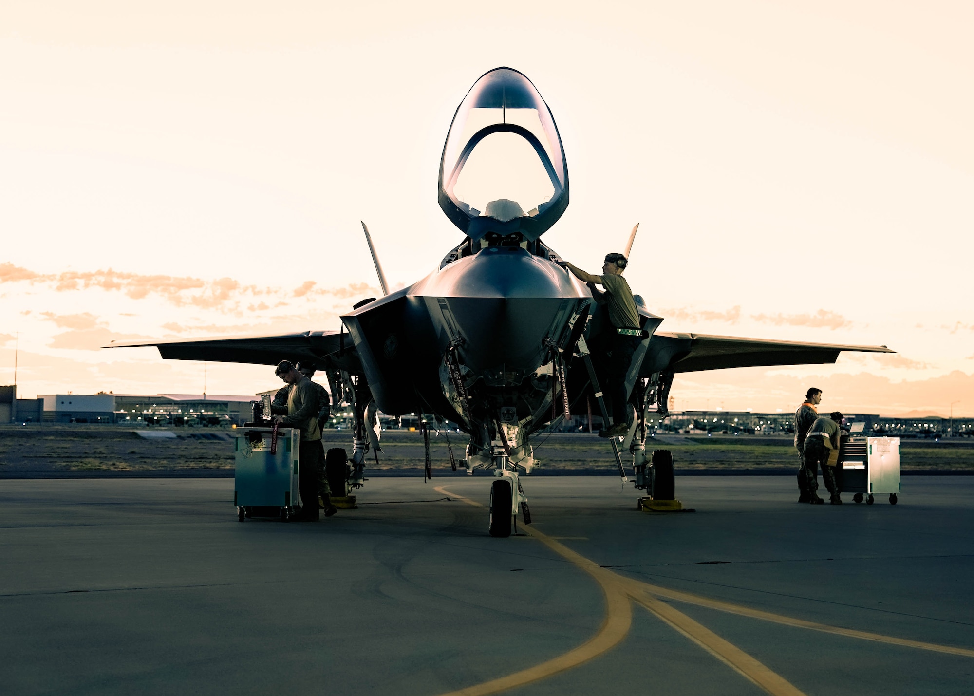 U.S. Air Force Airmen assigned to the 56th Fighter Wing prepare an F-35A Lightning II jet for a sortie by loading missiles during a Phase 2 Aircraft Generation exercise